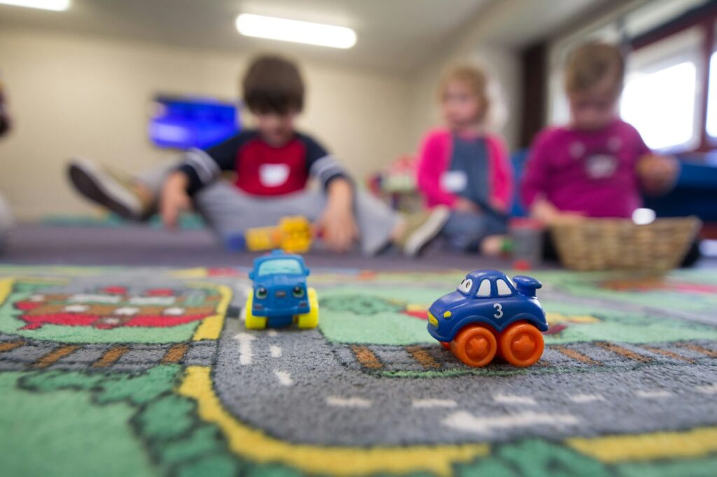 Photo by BBC Creative a group of children playing with toys on the floor